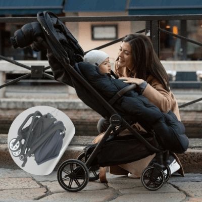 Chancelière-poussette-pliée-maman-parle-à-son-bébé-enveloppé-dans-une-chancelière-noire-dans-la-rue