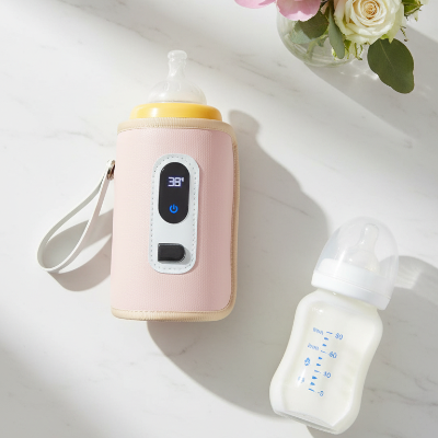 Chauffe-biberon rose flat lay