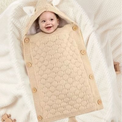 nid-d-ange-cosy-beige-bébé-souriant-enveloppé-confortablement